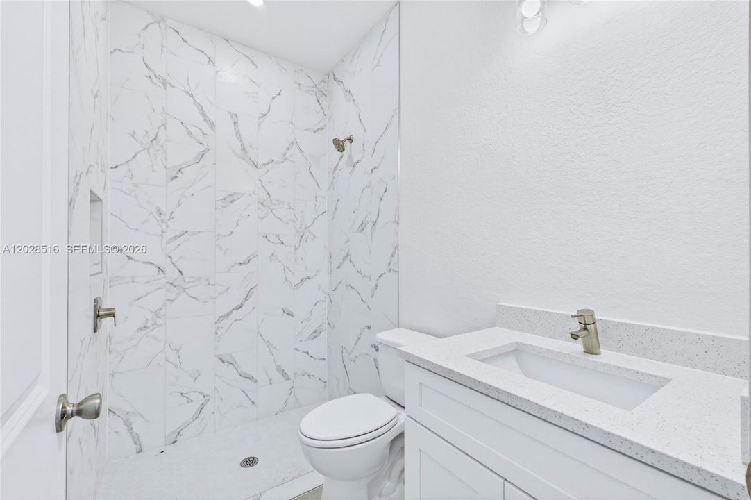 Spacious guest bathroom offering comfort and style for guests.