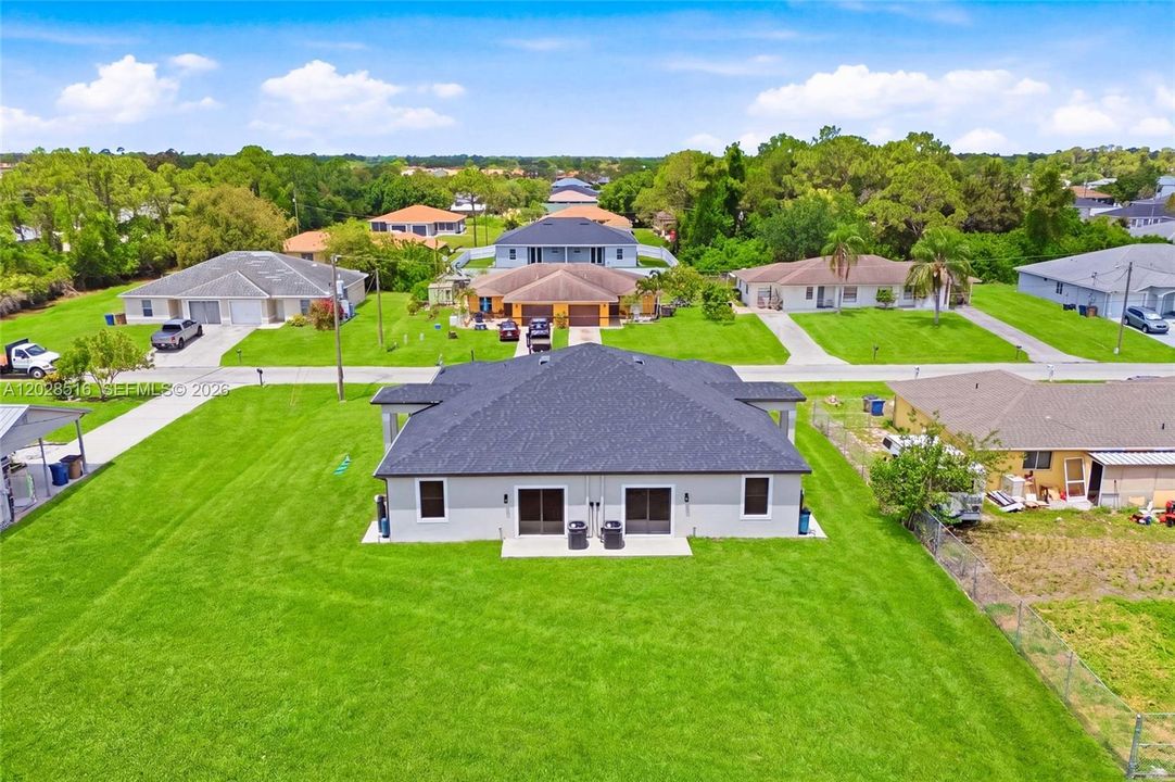 Drone view showcasing the backyard’s privacy and natural surroundings.