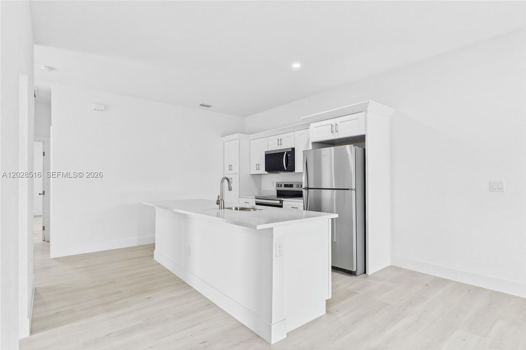 Generous living space in Unit 2 offering a warm and welcoming atmosphere.