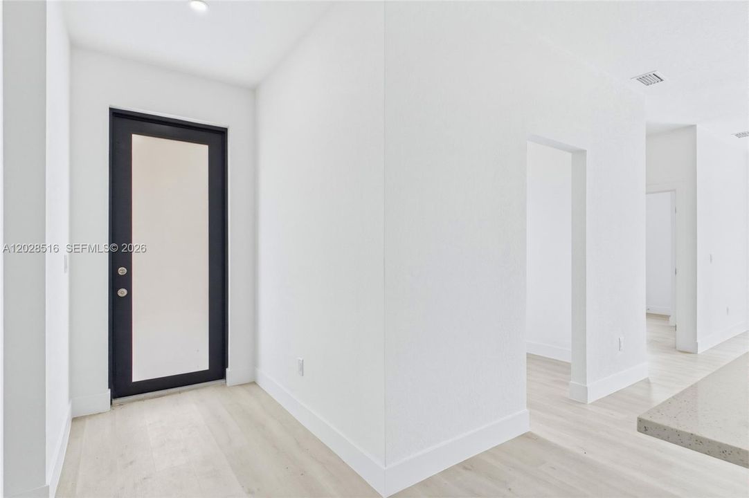 Grand entryway opening to a bright and airy floor plan.