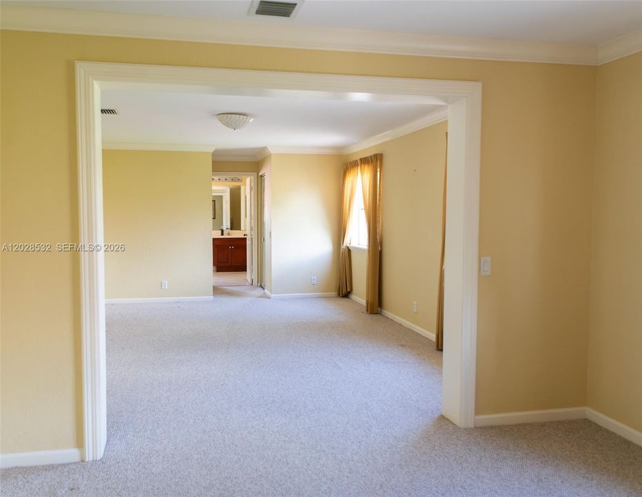 View from primary sitting area onto bedroom