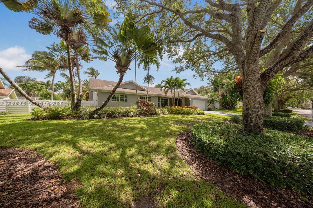 Oak trees and Mature landscapes adorn the front of the property.