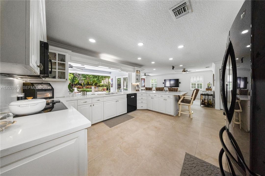 Kitchen with large snack counters and opens to the oversized family room - just ideal when entertaining.