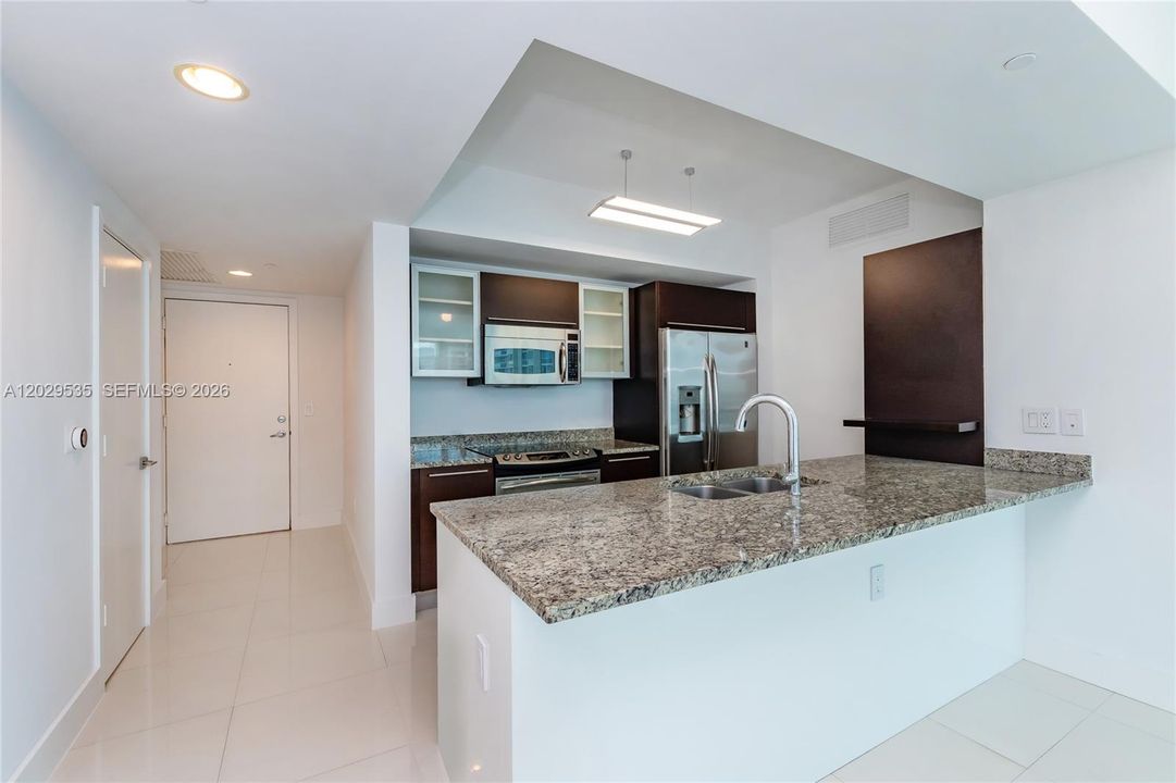 Modern kitchen, granite countertops, SS appliances, newer refrigerator