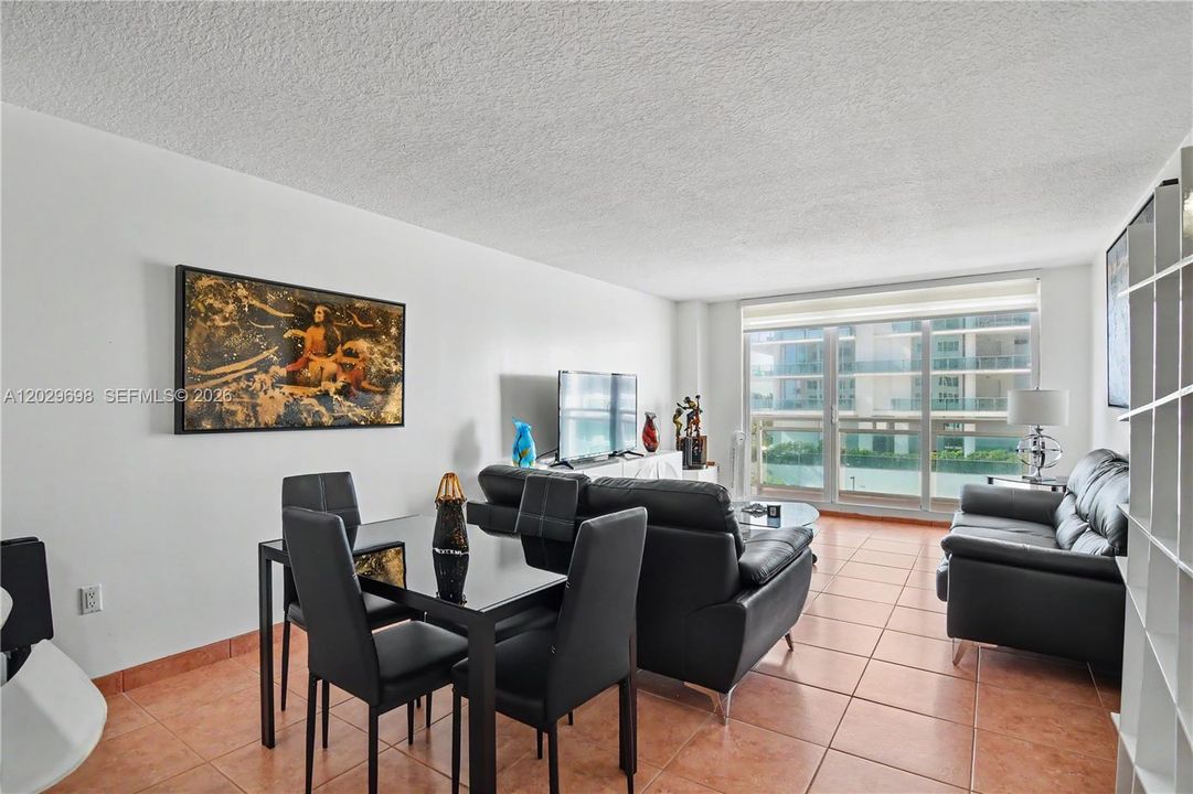 Open concept with kitchen, dining area and living room in one huge space. Impact resistant floor to ceiling sliding doors.