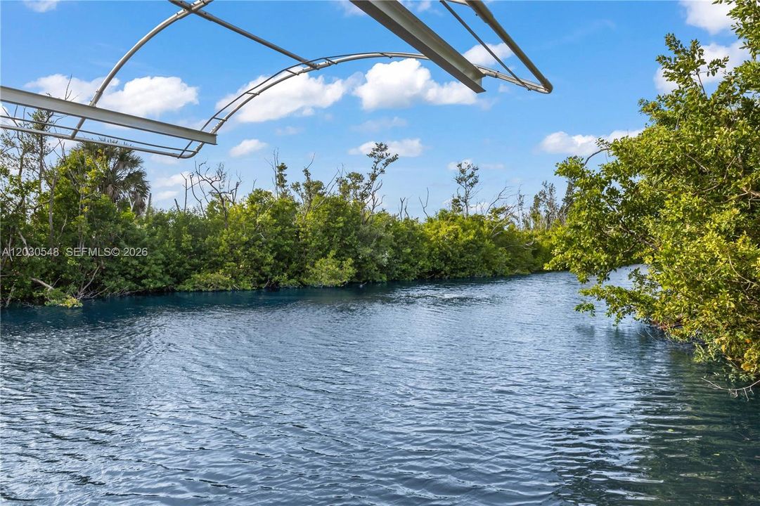 BEAUTIFULLY UPDATED, MOVE-IN-READY waterfront home offers the perfect combination of COASTAL CHARM, BOATING CONVENIENCE & RESORT-STYLE LIVING