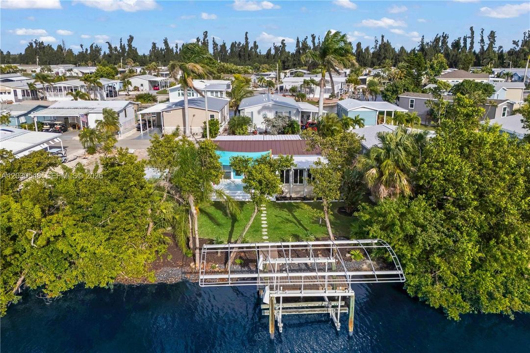 Situated on scenic canal, this 2 BED + 2 BATH manufactured HOME features PRIVATE DOCK & 10K-lb BOAT LIFT