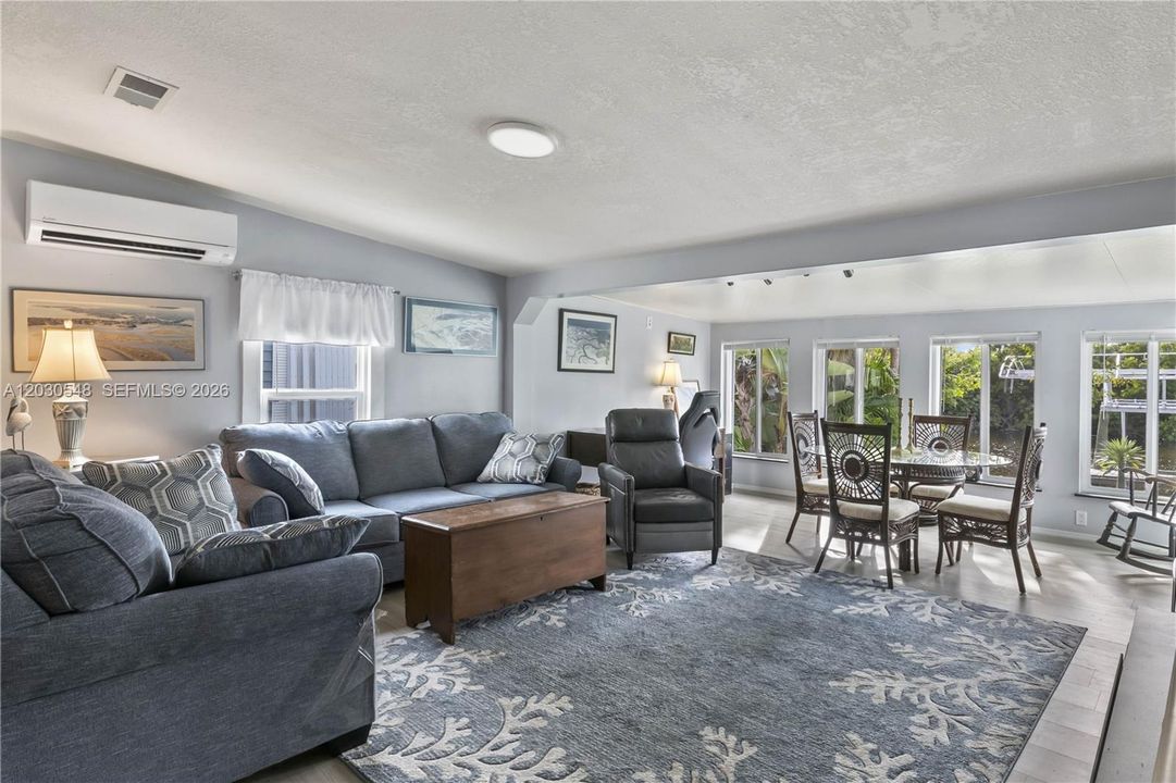 Inside, the bright & airy floor plan is filled w/ natural light, enhanced by expansive waterfront windows that frame peaceful canal views throughout the main living areas