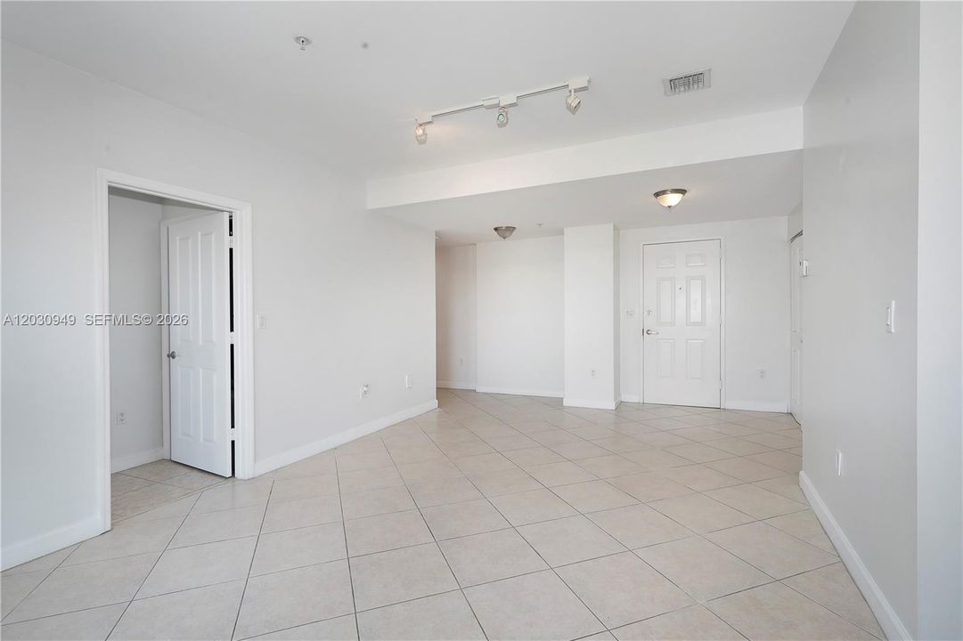 View from living area towards dining. bedrooms are on both sides, kitchen at end on left