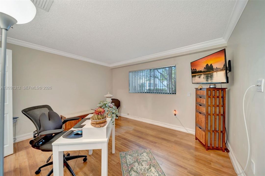 Downstairs guest bedroom with wood laminate flooring
