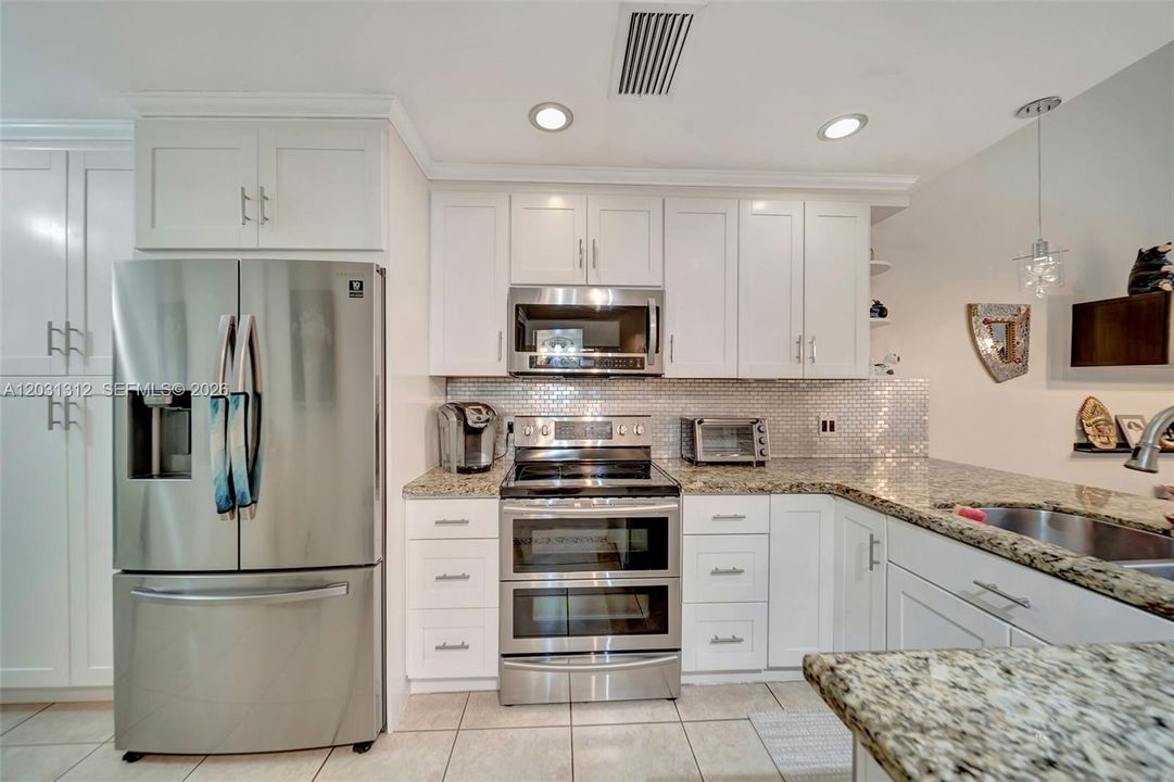 Stainless steel appliances to include a double oven and French Door refrigerator