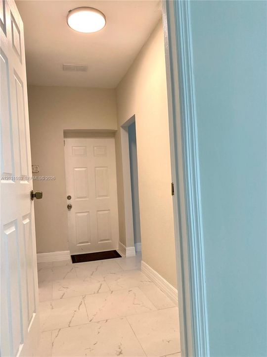 South side of house : to the front is access to pool and yard,to the right extra bedroom and to the left Laundry room