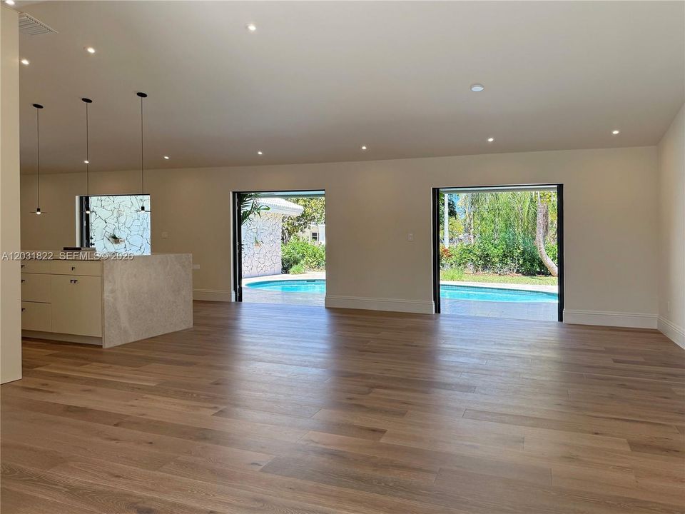 LIVING ROOM OPENS TO THE POOL PATIO