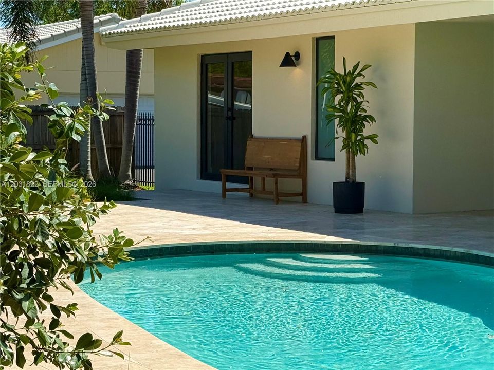 PRIMARY BEDROOM OPENS TO POOL