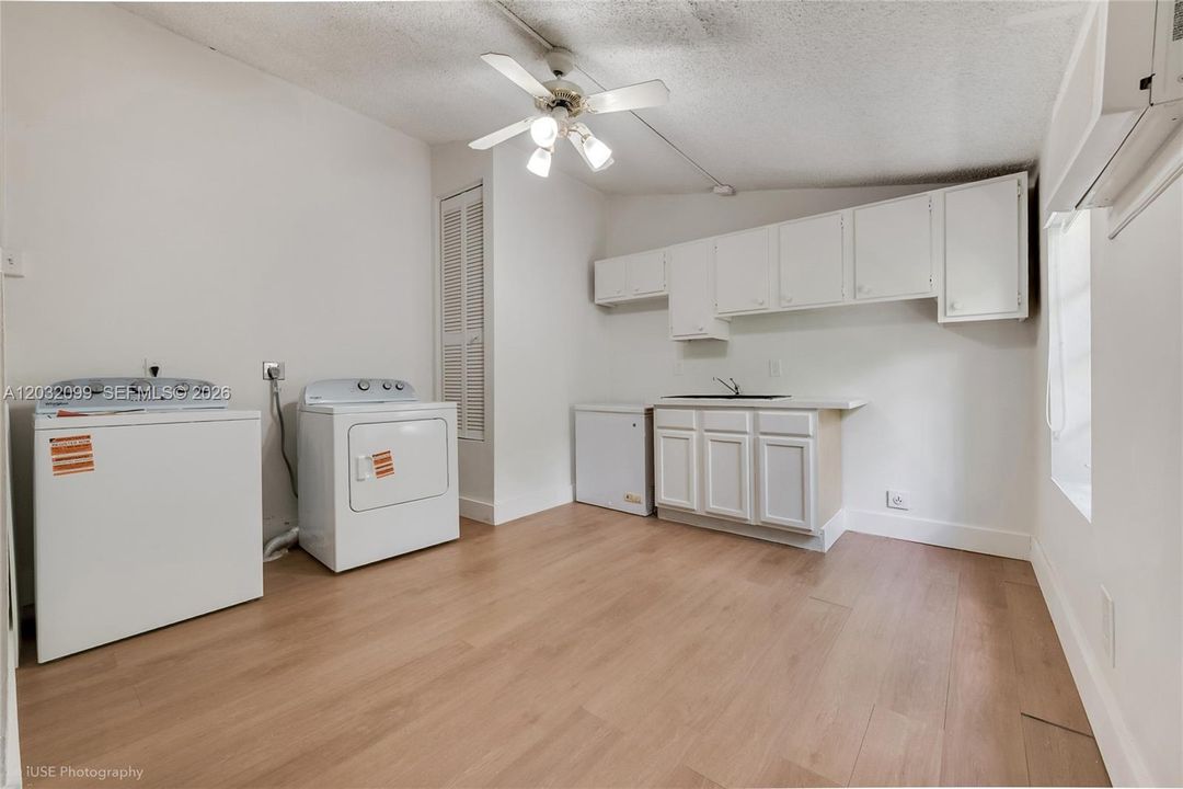 Large laundry room with exterior access has an additionl bathroom and can be used as an extra room for hobby/crafting room, home office, gym or guest suite.