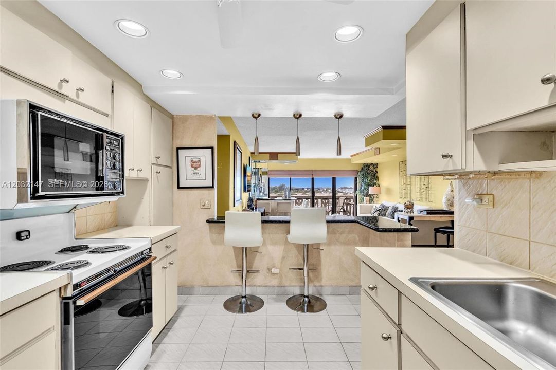 LARGE EAT IN KITCHEN IS IN GREAT CONDITION AND HAS A NEW STAINLESS STEEL REFRIGERATOR. THE BAR SEATING IS A GREAT PLUS!
