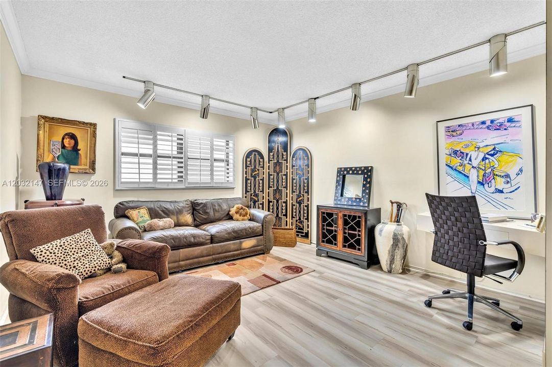 ENTER THE SECOND BEDROOM THAT IS PRESENTLY BEING USED AS A DEN/OFFICE AND CAN BE EASILY CONVERTED TO A BEDROOM. FEATURES INCLUDE CUSTOM WOOD PLANTATION SHUTTERS, A WALK IN CLOSET, BUILT INS FOR STORAGE, AND IT TOO IS SPACIOUS!