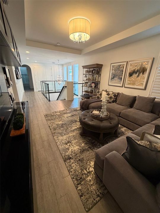 LOFT HAS A TRAY CEILING ADORNED WITH A FLUSHED PENDANT.  ARCHED WALK WAYS LEADING TO THE OTHER 4 BEDROOMS AND 2 BATHS.