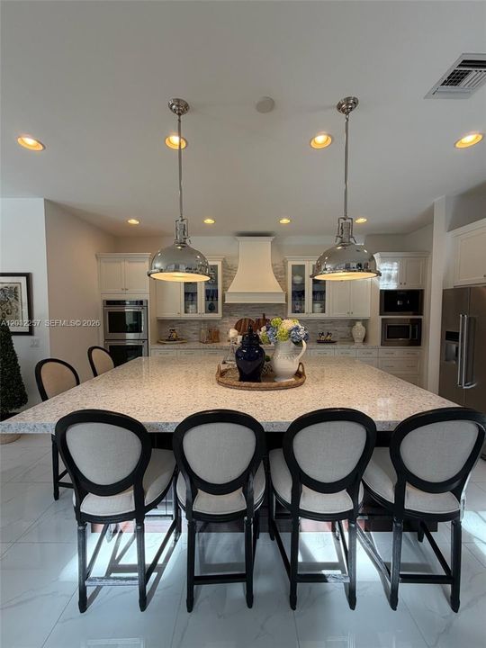 CHEF'S DREAM KITCHEN.  9'X6' ISLAND, CUSTOM HOOD, GLASS CABINET DOORS, SOFT CLOSE, PREMIUM APPLIANCES, DOUBLE OVEN, MIELE ESPRESSO COFFEE MACHINE, DESIGNER LIGHT PENDANTS, QUARTZ COUNTER TOP.