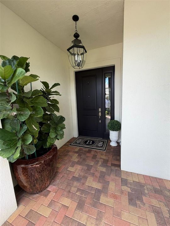 FRONT DOOR WITH COVERED ENTRY WAY.