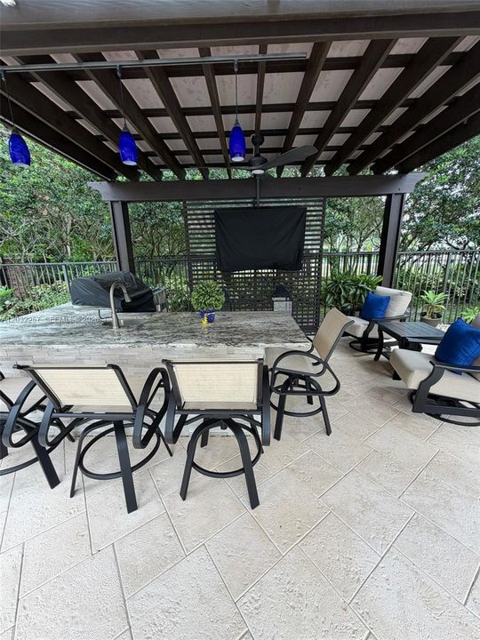 PERGOLA, WITH BBQ, SINK, DRINK COOLER, TV, GRANITE COUNTER TOP, AND RETRACTABLE AWNING