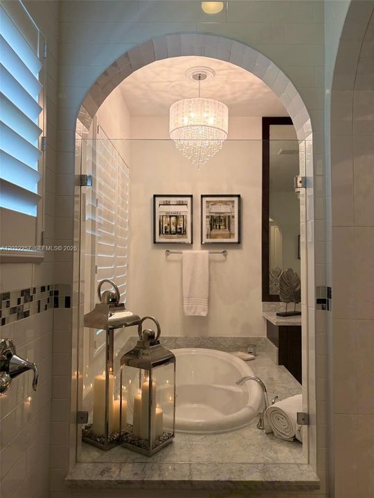 PRIMARY BATHROOM VIEW FROM THE WALK IN SHOWER.  PLANTATION SHUTTERS INSTALLED ON WINDOWS.