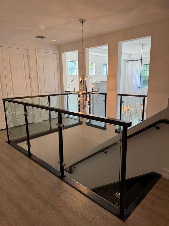 CUSTOM MADE GLASS RAIL ON SECOND FLOOR.