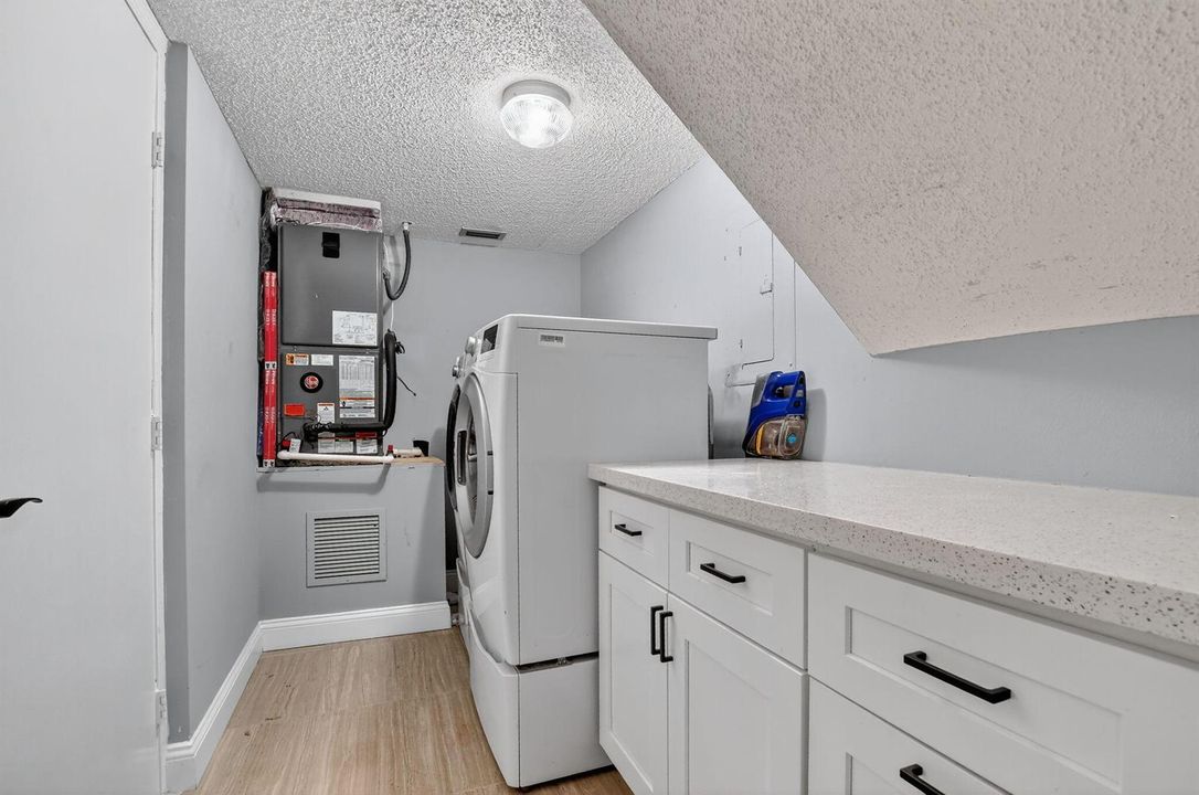 Laundry room next to kitchen