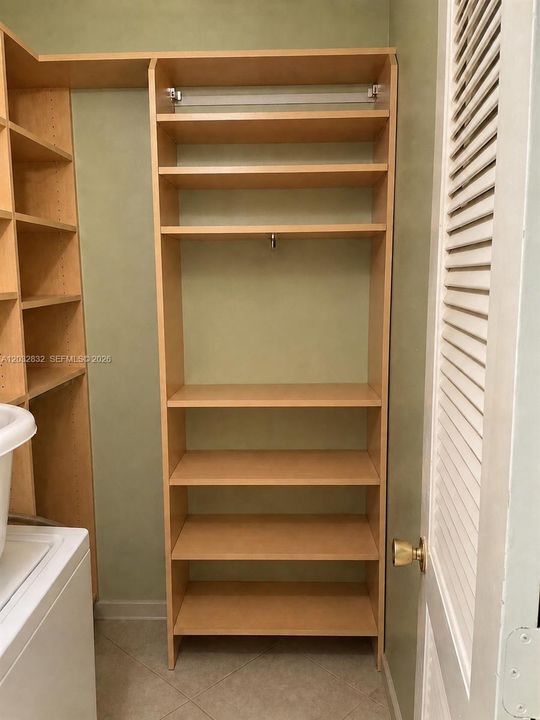 PRIMARY WALK IN CLOSET WITH WASHER
