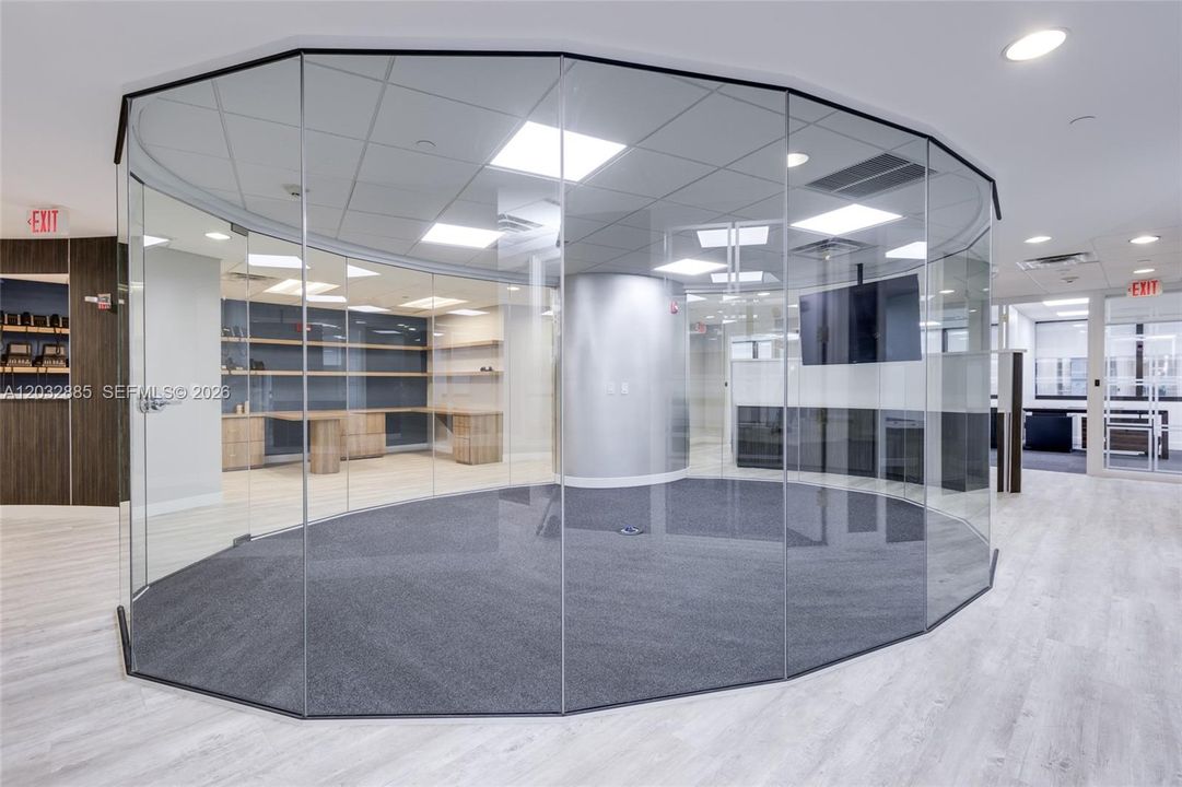 Glass walled conference room in center of suite
