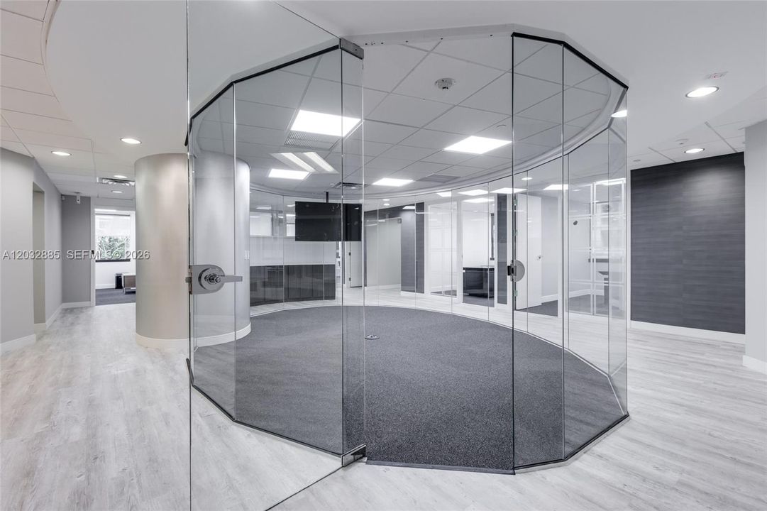 Glass walled conference room in center of suite