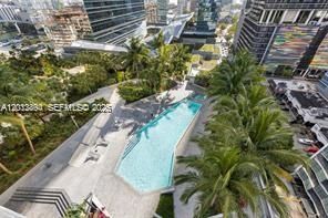 Resort-style pool deck with city views and lounge areas.