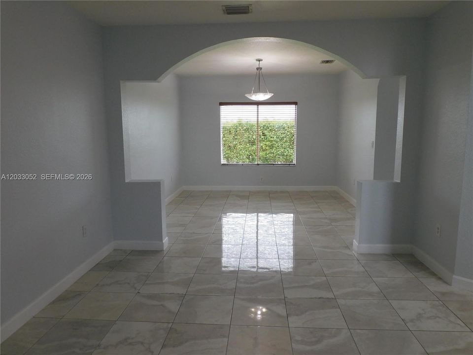 Dining room view from living room - property is fully tiled throughout.