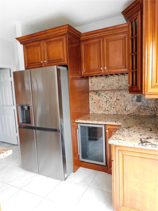 Refrigerator with front water and ice dispenser.
