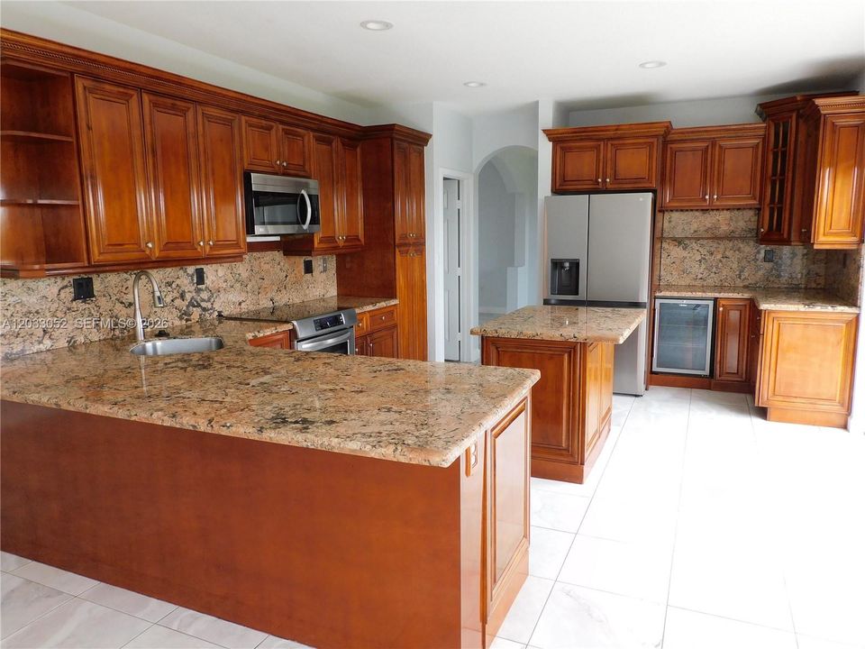 Wood Kitchen Kitchen with granite counter tops & backsplash, ss appliances.