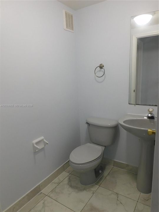 Downstairs half bath to service family room area and guests.