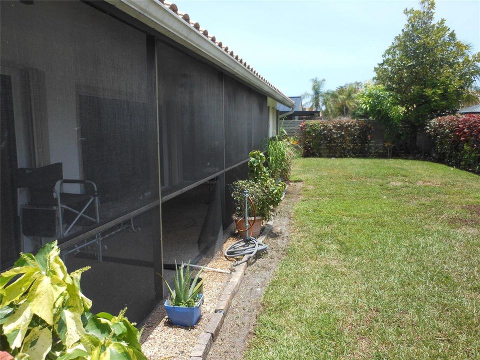 Back yard viw showing enclosed patio