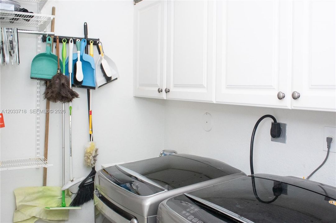 The laundry room is in the hallway to the left of the front entrance, the same hallway that leads to the Jack-and-Jill Bedrooms and bathroom. The Laundry Room is spacious and has cabinets for storage as well as a very usefull sink. Even the Laundry Room has expansive high ceilings.