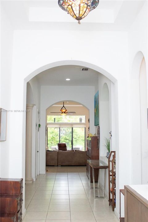 As you walk thru the Front Door, the incredible high ceilings make an impact. You immediately see the Family Room inthe far back and the light from the sliding glass doors.