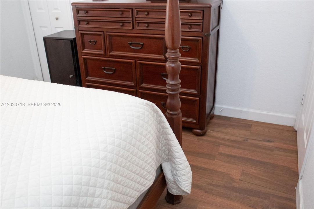 ALL bedrooms, including this Guest Room, have the same beautiful and durable updated Wood-Look Tile, including the closets.