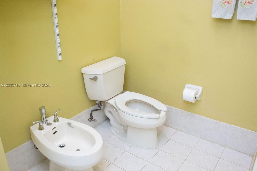 The Toilet and Bidet are in a separate spacious room, along with shelving for storage as well as a linen closet.