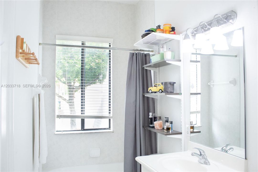 This Bathroom connects directly to the First Bedroom as well as to the Second Bedroom (currently used as an Office), and it also has a door that leads to the exterior of the home. The large window provides wonderful natural light.