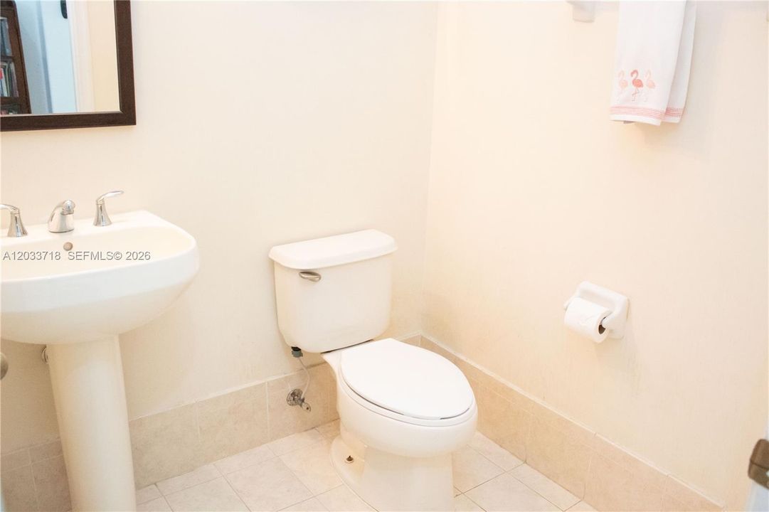 The half-bath is not only spacious but also offers expansive high ceilings.