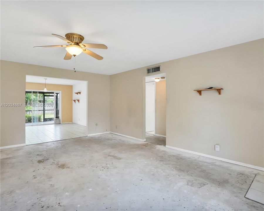 LIVING ROOM FACING THE DINING AND BEDROOM HALLWAY
