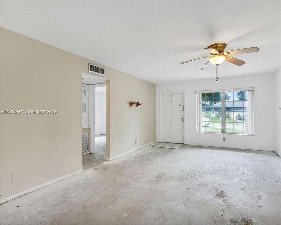 LIVING ROOM FACING THE FRONT DOOR AND HALLWAY TO BEDROOMS