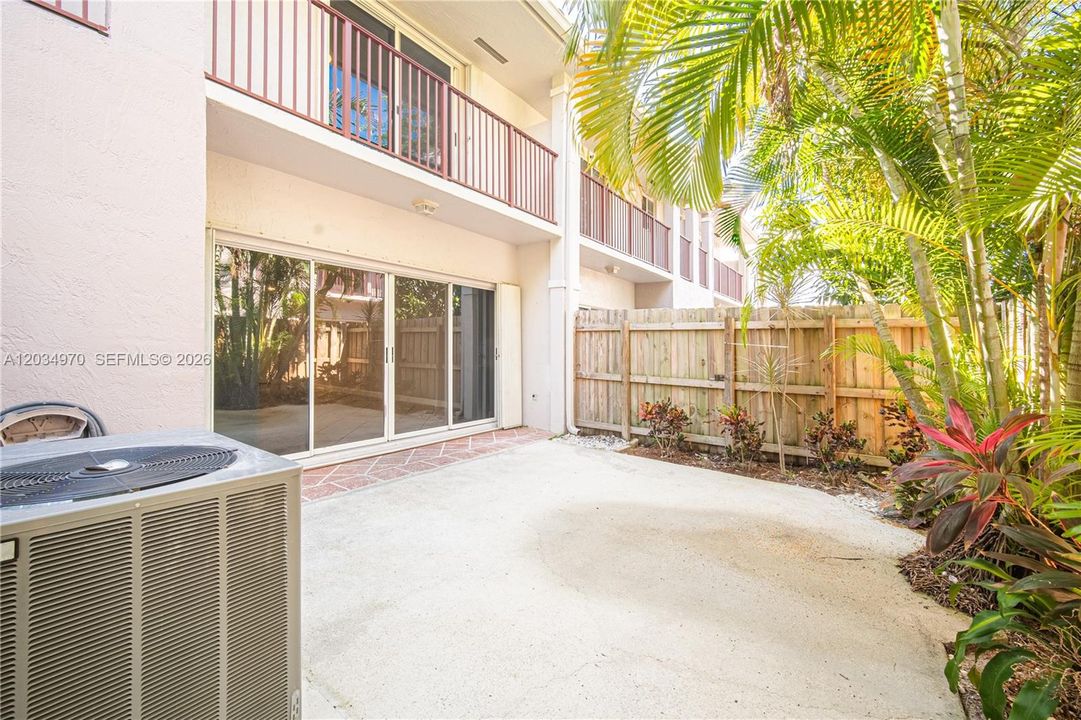Patio off the Living Rm.  Master Bedroom balcony above.  Accordion shutters throughout the townhouse