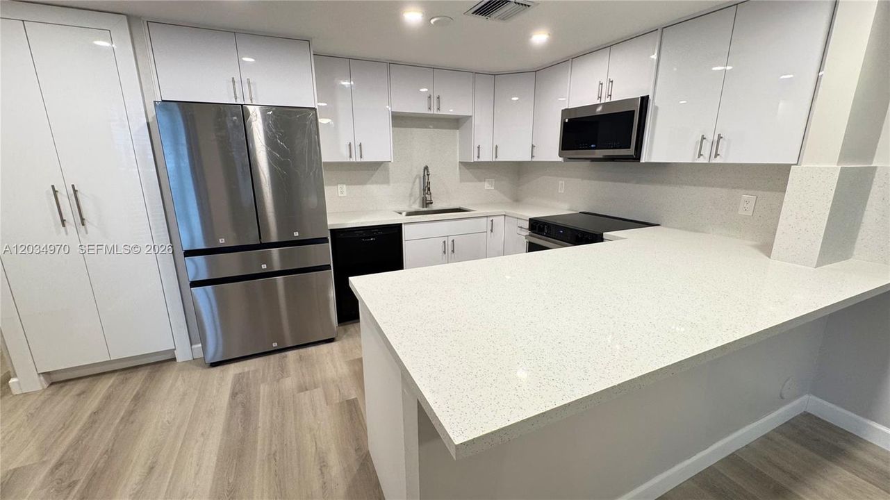 Family room view featuring the eat-in kitchen counter