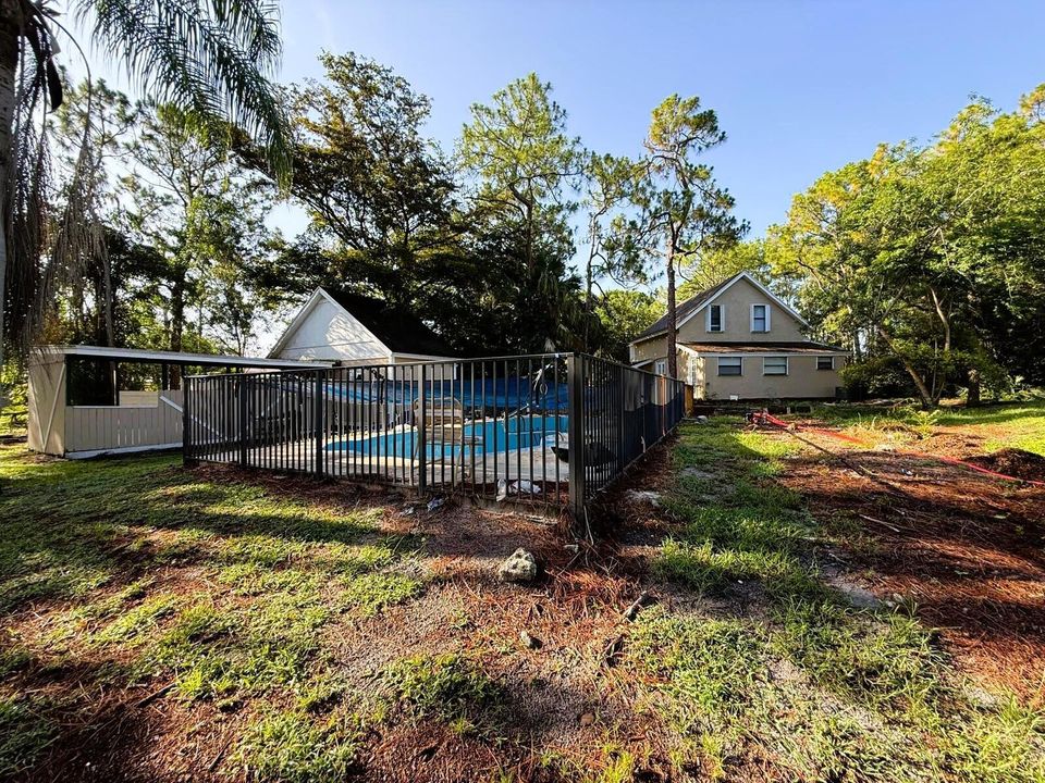 side of house with pool and stalls