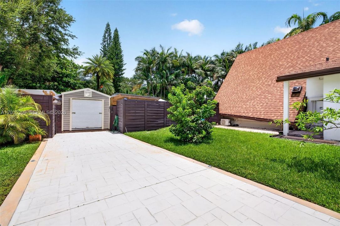 Extra long driveway on main house side with storage shed, and additional 2 more beautiful air conditioned sheds which can be used for office space, as well as outdoor covered storage area