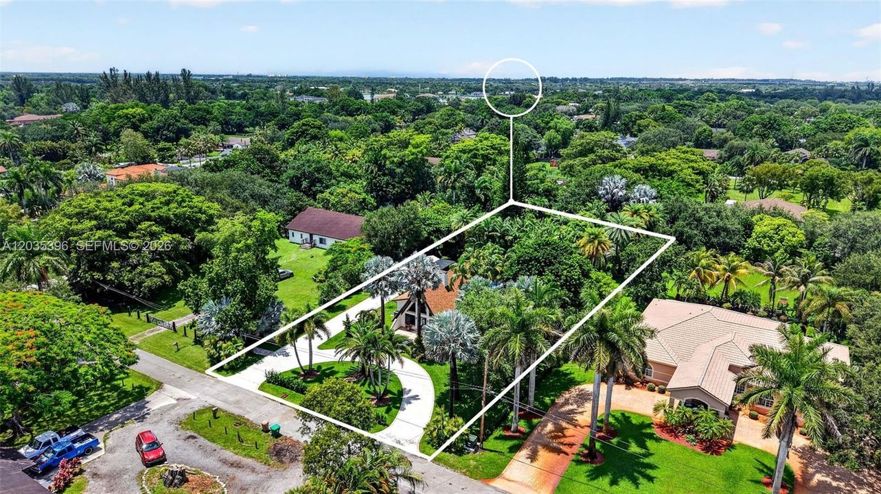 Large property with gorgeous grounds and mature trees, view of guest house on north and main house on south, separated by fence